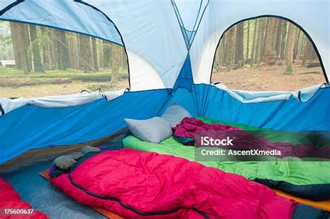 Tent interior with multiple sleeping mats and blankets