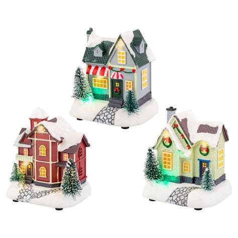 Ilustracija božične vasice s praznično okrašenimi hiškami in lučkami