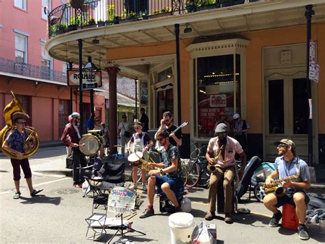 New Orleans French Quarter street with balconies and jazz musicians
