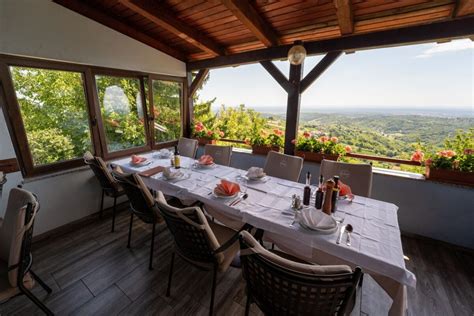 Gostje uživajo v hrani na terasi smučišča s pogledom na gore